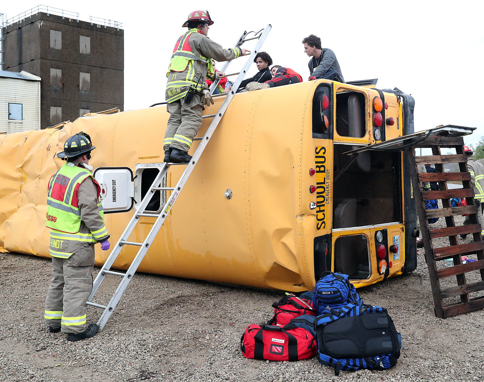 Firefighters assess student injuries in bus crash drill